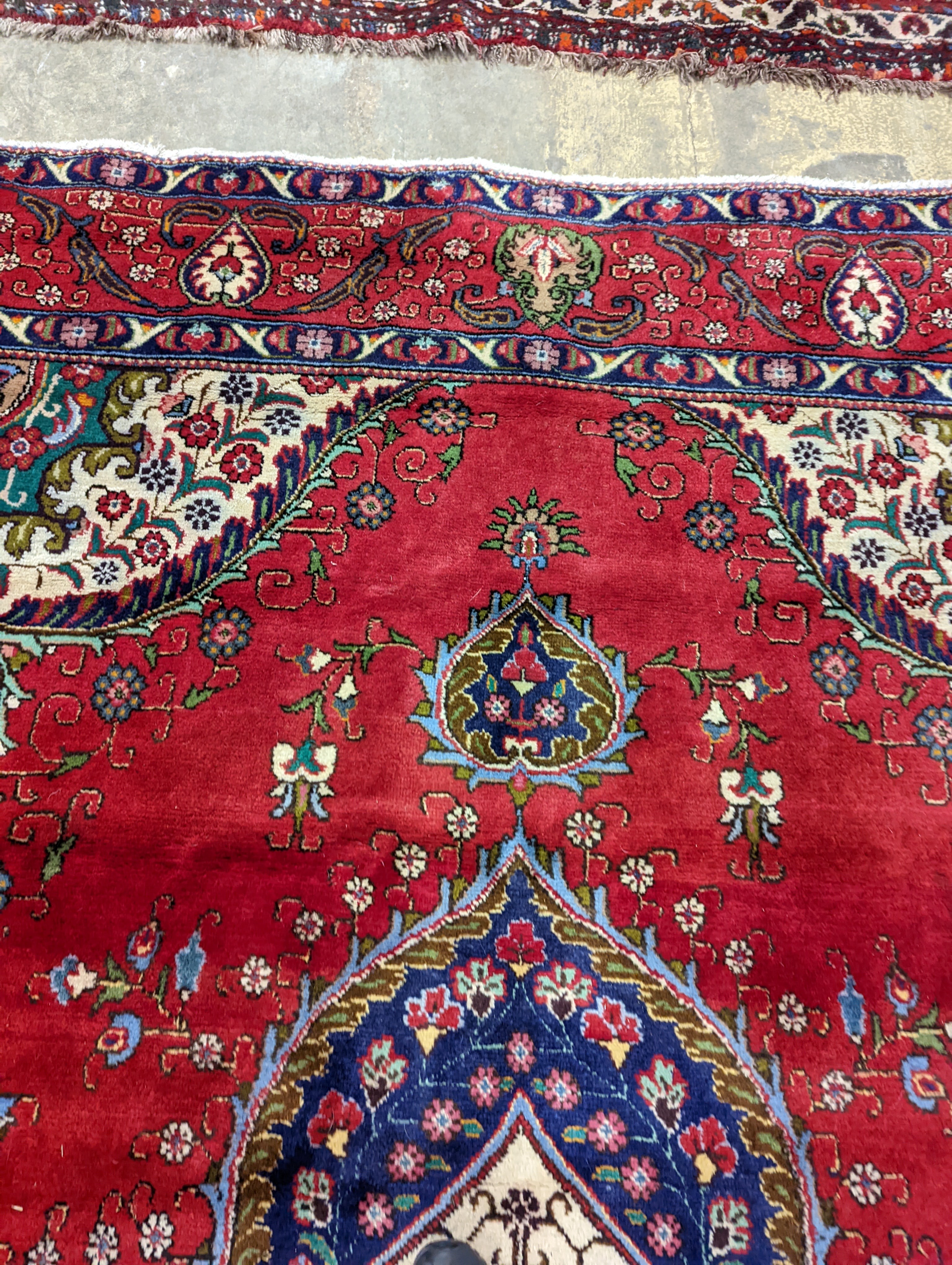 A Tabriz red ground carpet, 380 x 300cm